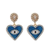 Blauwe oorbellen in hartvorm met oog en strass._