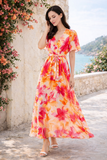 Elegante maxi jurk in oranje-roze bloemenprint met strikceintuur_