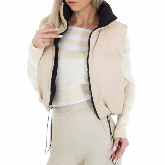 Korte omkeerbare beige bodywarmer.