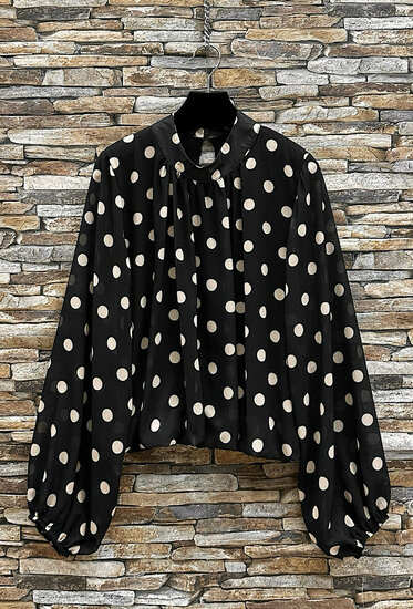 Elegante zwarte blouse met beige stippen en volumineuze mouwen