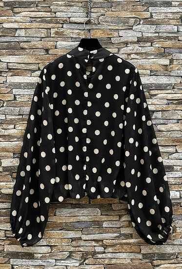 Elegante zwarte blouse met beige stippen en volumineuze mouwen