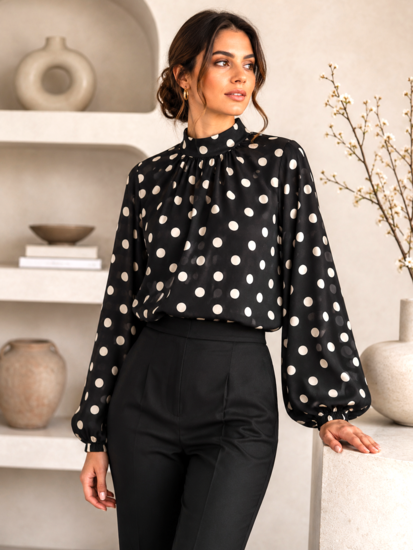 Elegante zwarte blouse met beige stippen en volumineuze mouwen